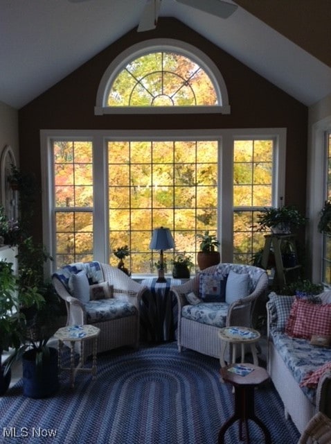 sunroom featuring ceiling fan and vaulted ceiling