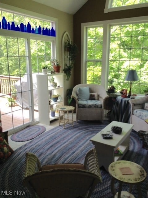 sunroom featuring a wealth of natural light and vaulted ceiling