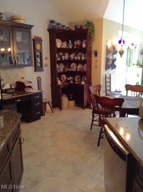 dining room with lofted ceiling and an inviting chandelier