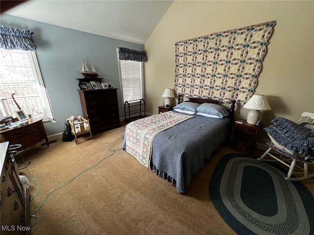 carpeted bedroom with vaulted ceiling