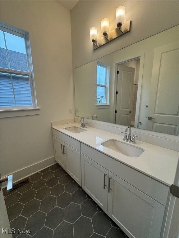 bathroom featuring vanity, tile patterned floors, and a healthy amount of sunlight