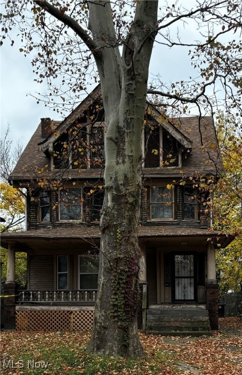 view of side of property with covered porch