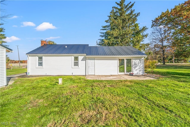 back of house featuring a patio area and a yard