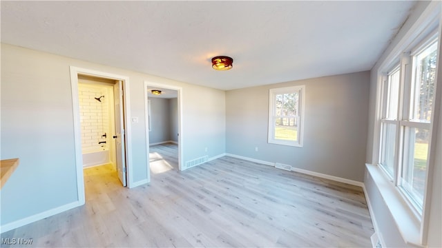 spare room featuring light hardwood / wood-style flooring