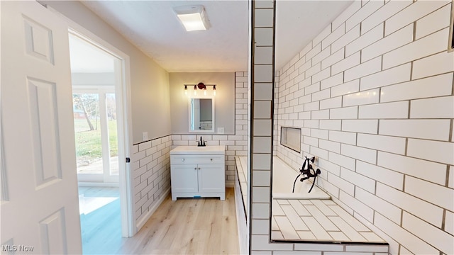 bathroom with vanity, tile walls, and hardwood / wood-style flooring