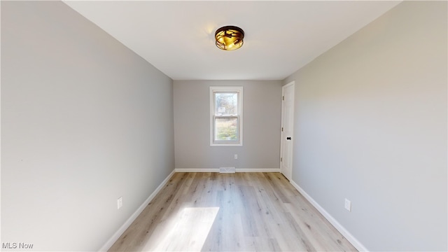 unfurnished room with light wood-type flooring