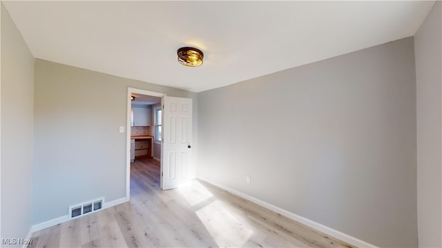 spare room featuring light hardwood / wood-style floors