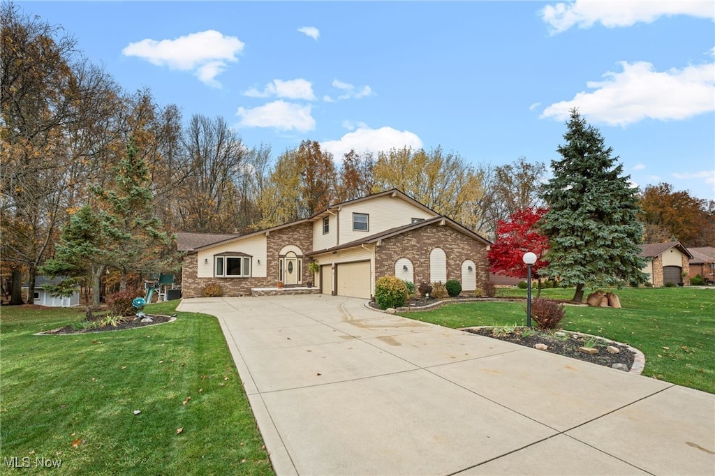 view of front of house with a front lawn and a garage