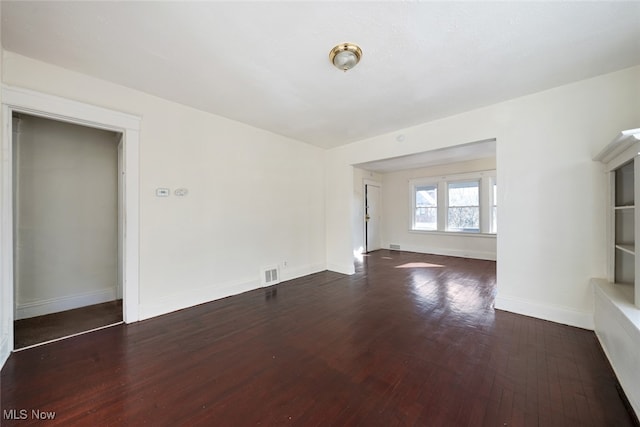 unfurnished room featuring dark hardwood / wood-style floors