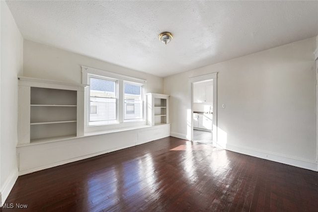 interior space with dark hardwood / wood-style floors and a textured ceiling