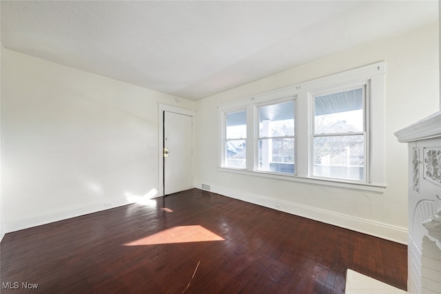 unfurnished room featuring dark wood-type flooring