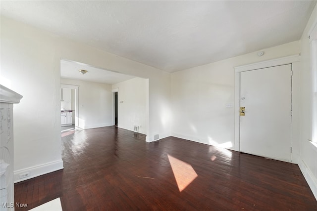 unfurnished living room with dark hardwood / wood-style flooring