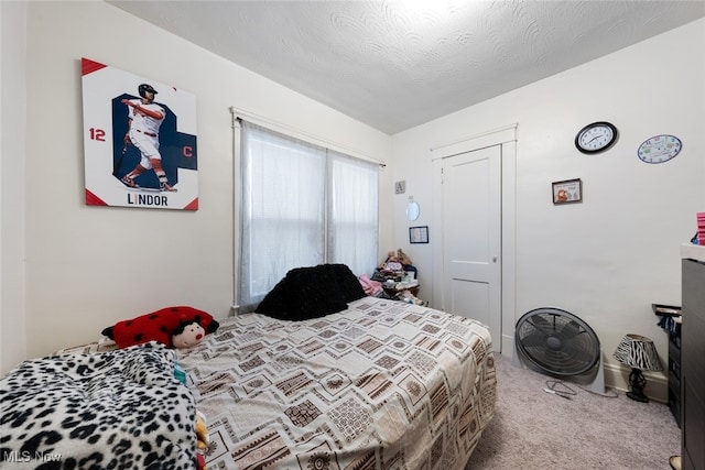 carpeted bedroom featuring a textured ceiling