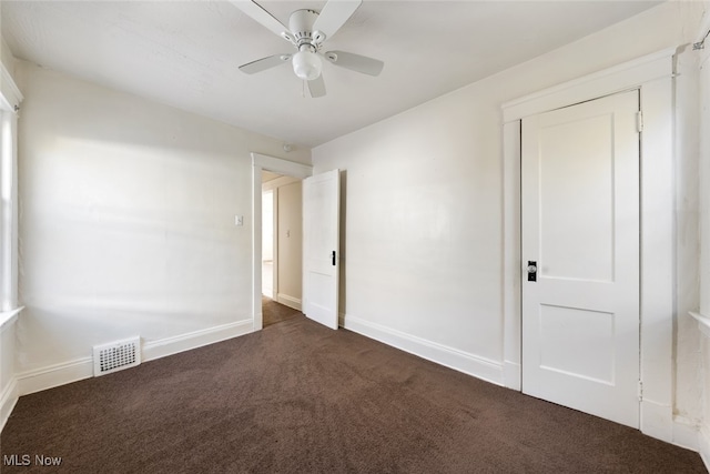 carpeted spare room with ceiling fan