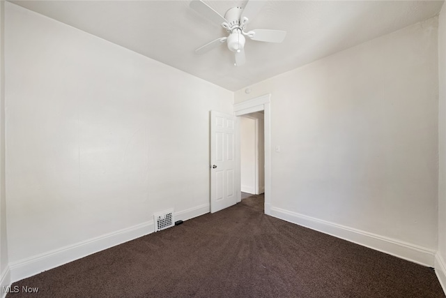 carpeted spare room featuring ceiling fan