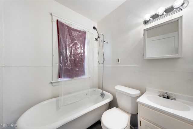 bathroom featuring plenty of natural light, vanity, a tub to relax in, and toilet