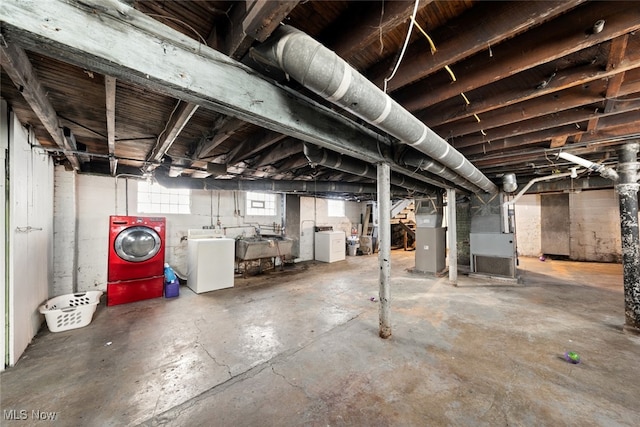 basement featuring independent washer and dryer and heating unit