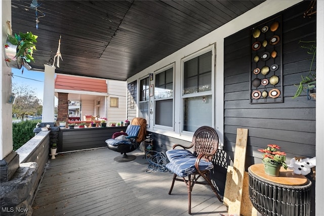 wooden terrace featuring covered porch