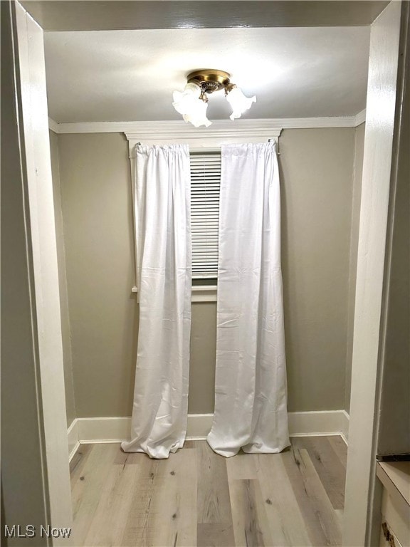 bathroom featuring hardwood / wood-style floors and ornamental molding