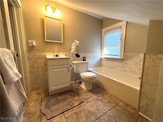 bathroom with toilet, vanity, tile walls, and tile patterned floors