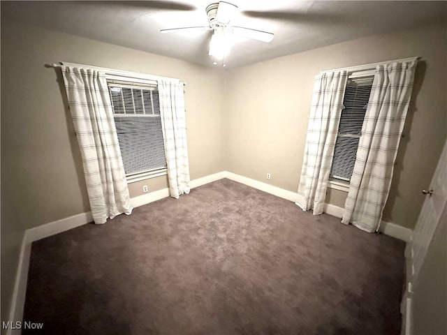 unfurnished bedroom with dark colored carpet and ceiling fan