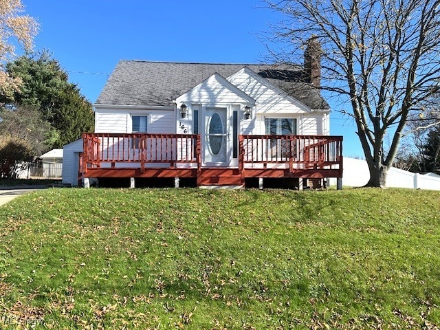 view of front facade with a front lawn and a wooden deck