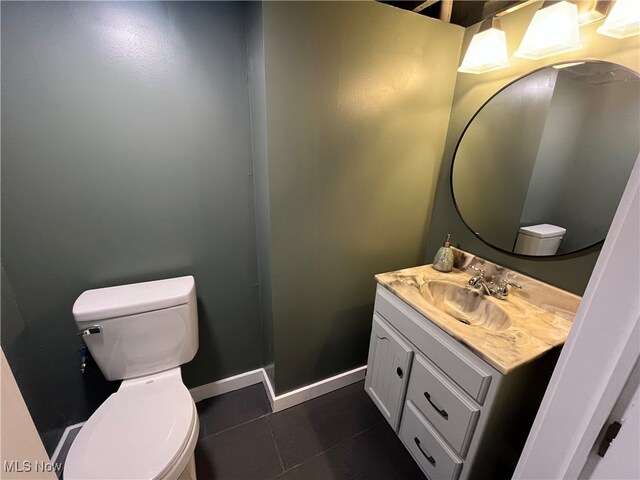 bathroom featuring vanity, tile patterned flooring, and toilet