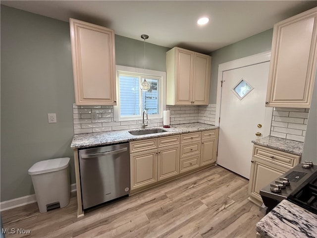 kitchen featuring sink, tasteful backsplash, stainless steel dishwasher, hanging light fixtures, and light hardwood / wood-style flooring