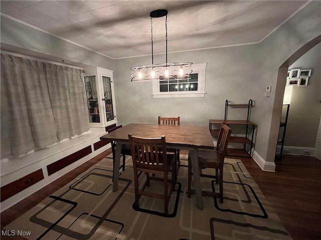 dining room with crown molding and dark hardwood / wood-style flooring