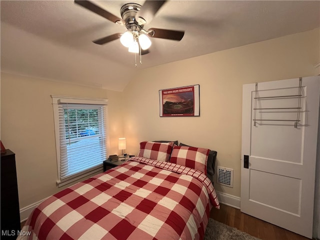 bedroom with lofted ceiling, ceiling fan, and dark hardwood / wood-style floors