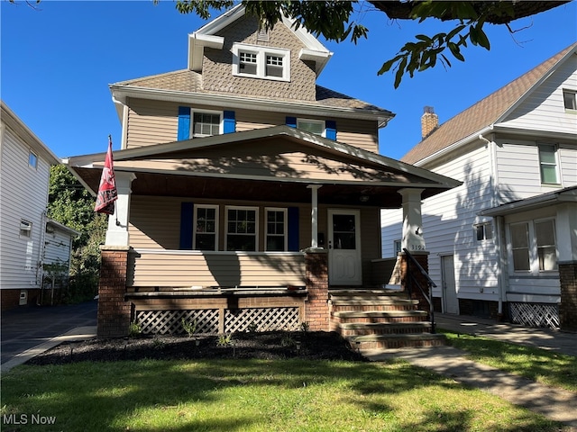 view of front facade with a porch and a front yard