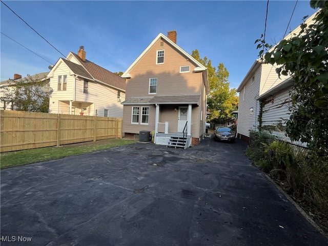 rear view of house featuring cooling unit