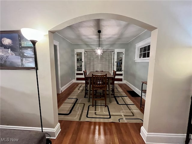 dining area featuring dark hardwood / wood-style flooring and a notable chandelier