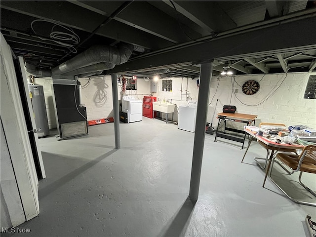 basement with gas water heater, sink, and washer and clothes dryer