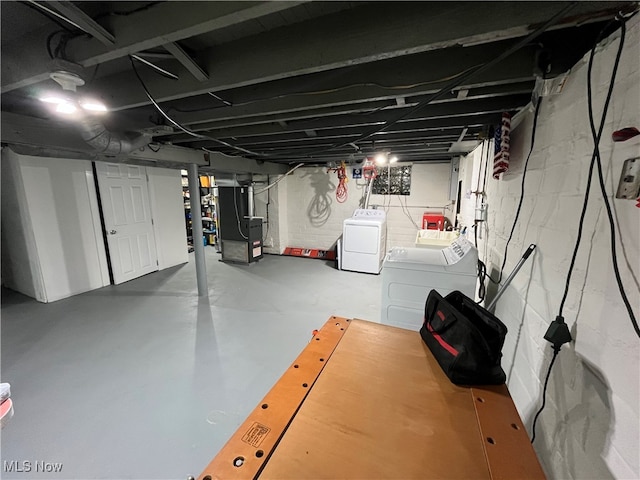 basement with heating unit and washing machine and clothes dryer