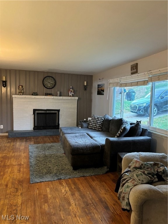 living room with a fireplace and hardwood / wood-style flooring