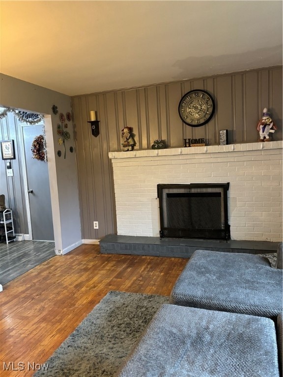 living room featuring a fireplace and dark hardwood / wood-style flooring