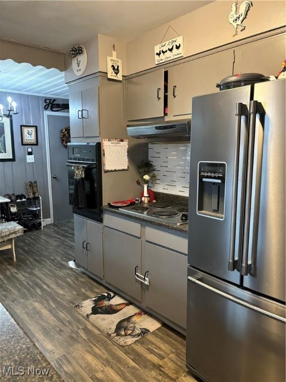 57365 Washington Blvd, Martins Ferry, OH 43935 - kitchen featuring stainless steel appliances, exhaust hood, dark countertops, and dark wood-type flooring