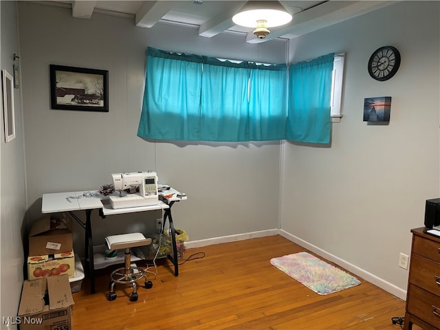 home office featuring beam ceiling and light hardwood / wood-style flooring