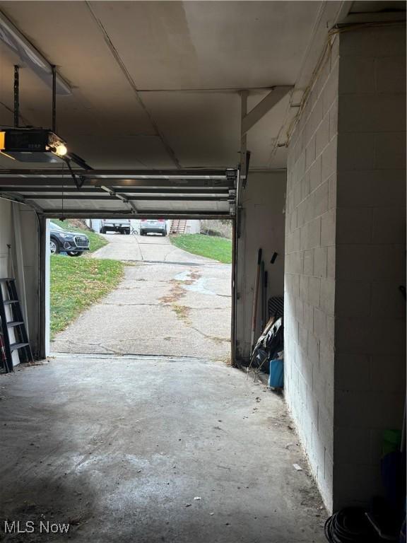 57365 Washington Blvd, Martins Ferry, OH 43935 - garage with a garage door opener and concrete block wall