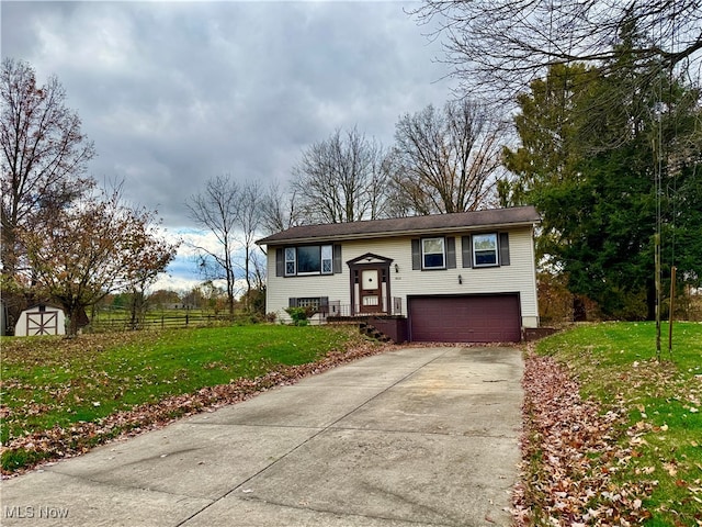 split foyer home featuring a garage and a front lawn