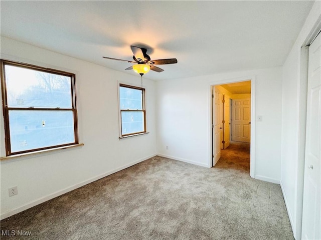 unfurnished bedroom featuring ceiling fan and light carpet