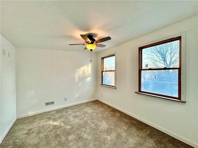 carpeted spare room with vaulted ceiling and ceiling fan