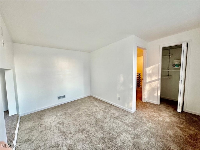 unfurnished bedroom featuring carpet flooring and a closet