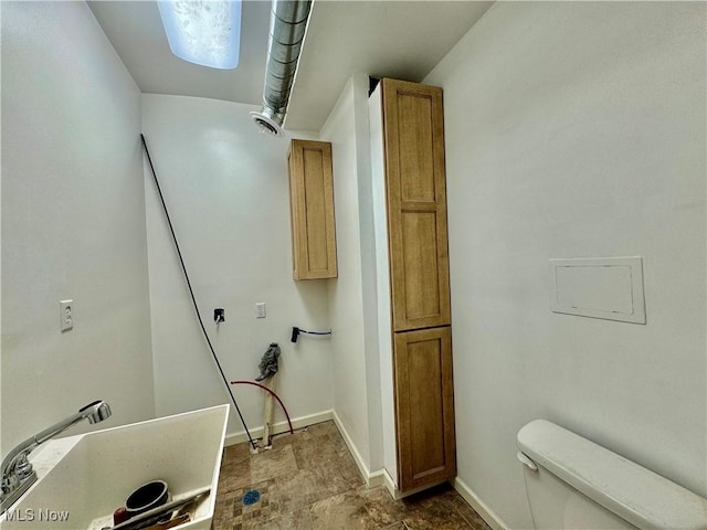 bathroom featuring sink and toilet