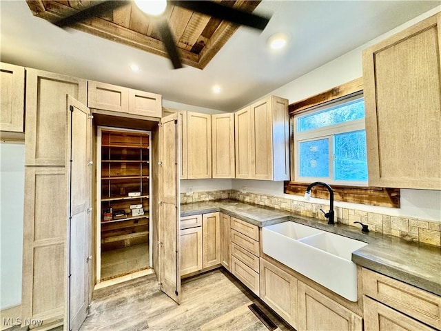 kitchen with sink, light wood-type flooring, and light brown cabinets