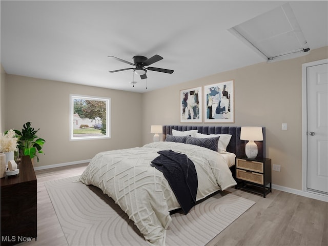 bedroom with ceiling fan and light hardwood / wood-style floors