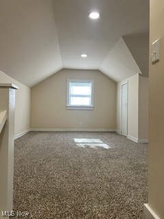 bonus room with carpet floors and lofted ceiling