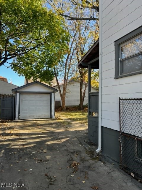 view of property exterior with a garage and an outdoor structure