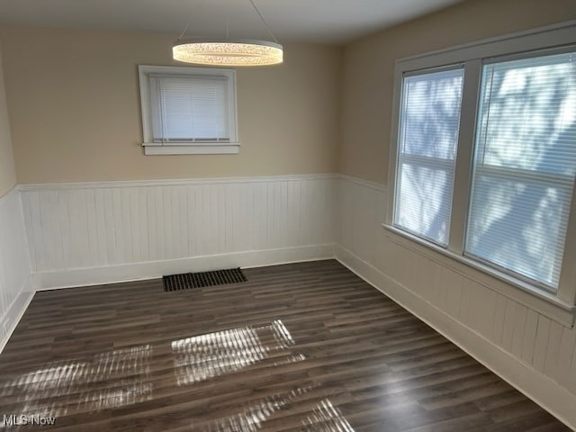 spare room featuring dark wood-type flooring